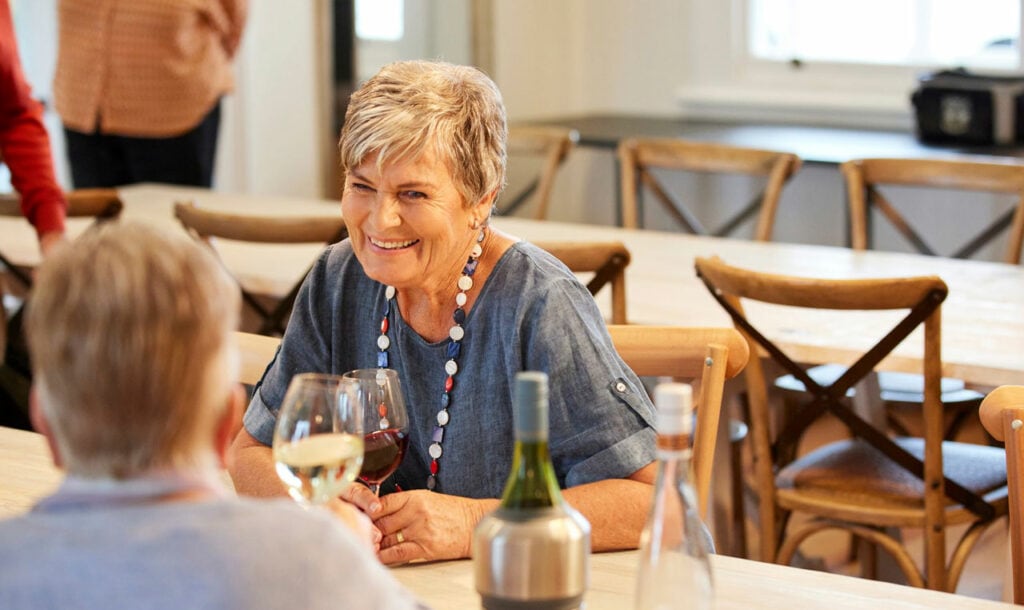 Older woman enjoying a glass of wine at Retirement Village in Hamilton