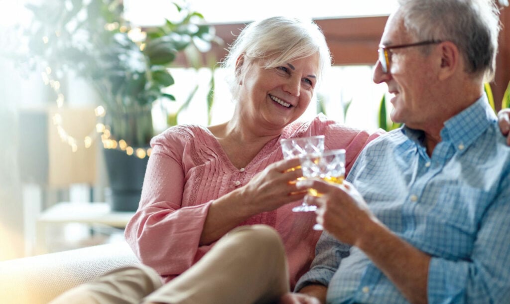 Happy elderly couple enjoying a drink at their Tauranga Retirement Home