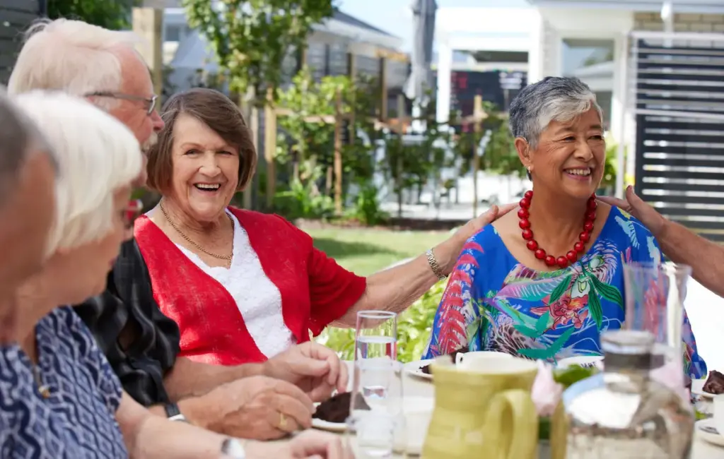 Retirement village residents celebrate at a lunch together.