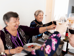 Residents-at-a-Karaka-Pines-Villages-having-a-celebration-wine-glasses-in-hand-cheering